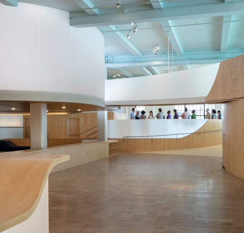 Interior of the Bronx Children's Museum with wood flooring and curved wooden elevated walkways
