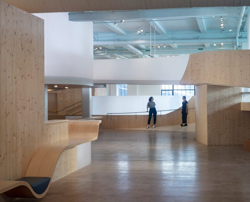Interior of the Bronx Children's Museum with wood flooring and curved wooden elevated walkways