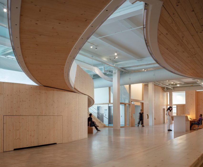 Interior of the Bronx Children's Museum with wood flooring and curved wooden elevated walkways