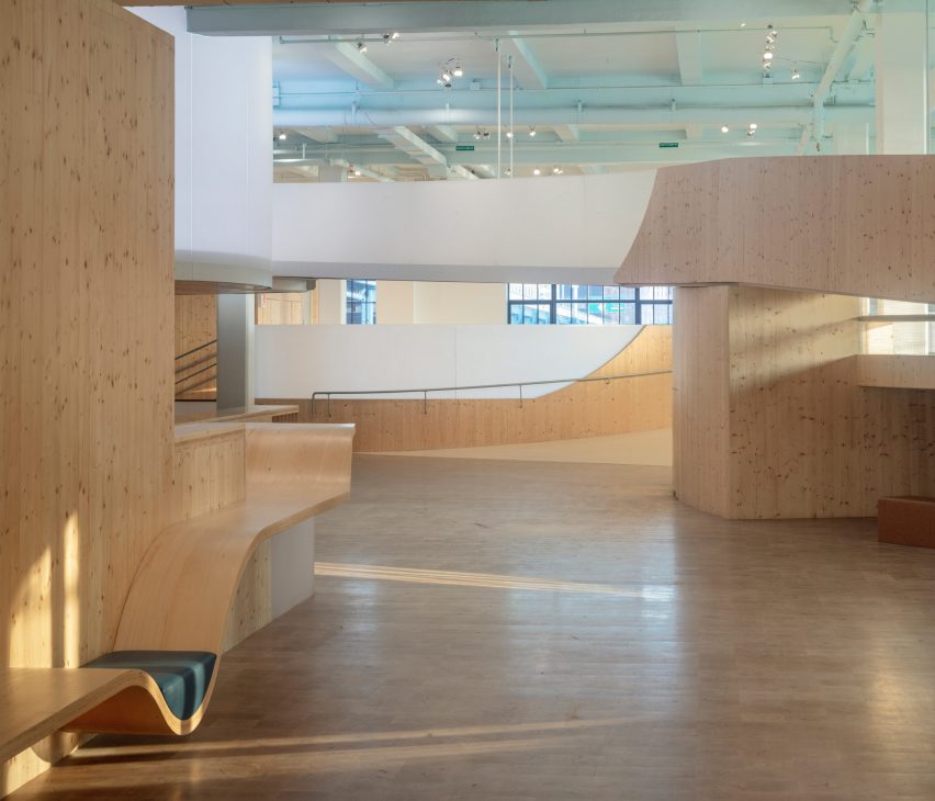 Interior of the Bronx Children's Museum with wood flooring and curved wooden elevated walkways