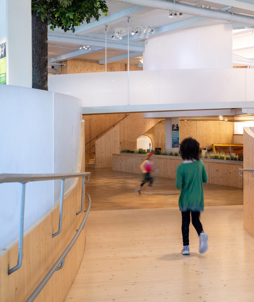 Interior of the Bronx Children's Museum with wood flooring and curved wooden elevated walkways