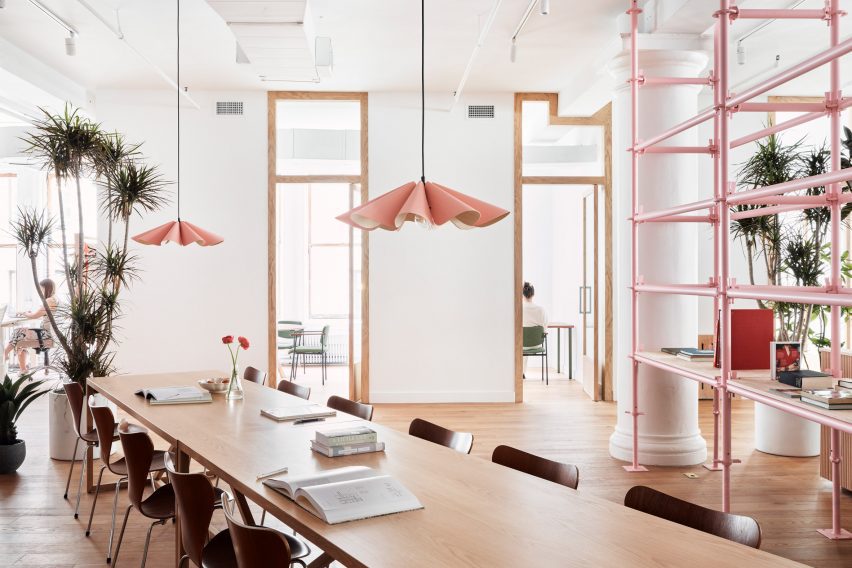 Pleated pendant lights hang above a long table