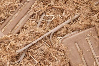 Pieces of a chair by Prowl Studio and M4 Factory on a bed of sawdust
