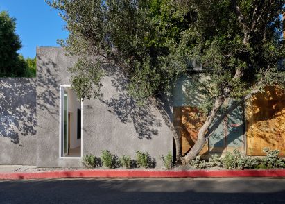 South facade of the building, featuring grey stucco