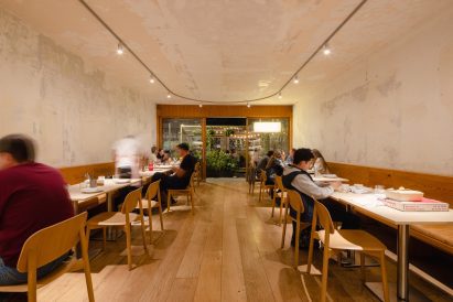 Diners enjoying pizza at night