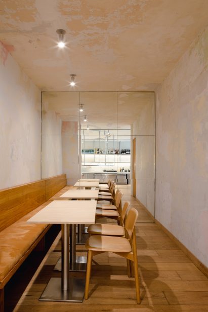 Chairs and tables reflected in a mirrored wall