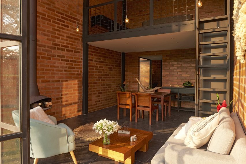 Open-plan living space with brick walls and mezzanine level