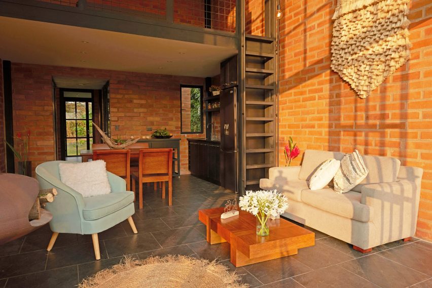Open-plan living space with brick walls and mezzanine level