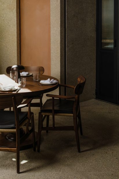 Plastered wall and wooden table in Porto restaurant interior