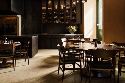 Green door and wooden table in Porto restaurant