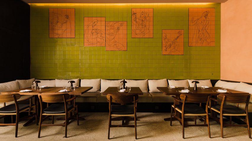 Wooden seating area below hand-painted mural by Álvaro Siza