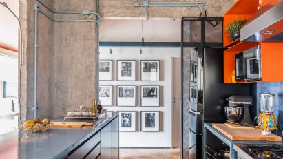 Kitchen at the RF Apartment with concrete walls and peach ceiling