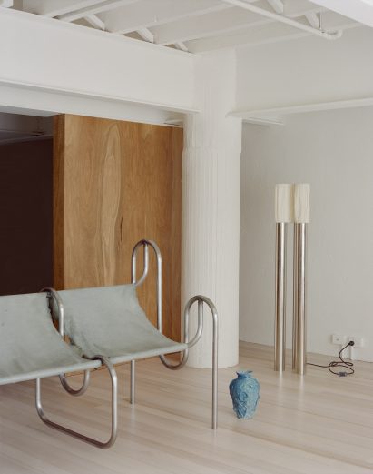 Grey chairs in living room with white column in corner