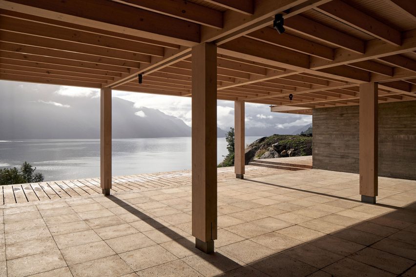 Paved outdoor space with a structure overhead and timber columns
