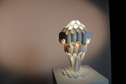 Lamp made up of tubes in front of grey backdrop