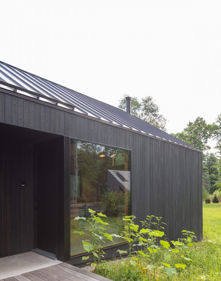 Black timber-clad home in a garden