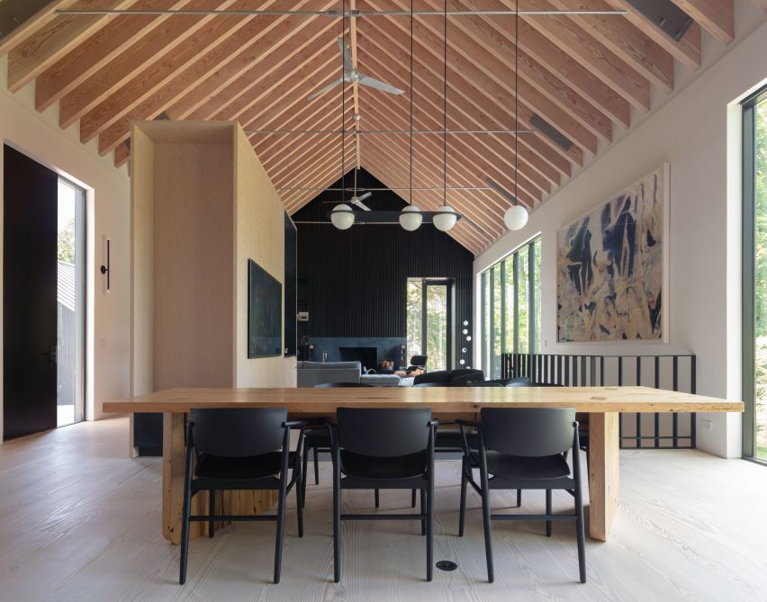 Open-plan living and dining space with an exposed timber pitched roof