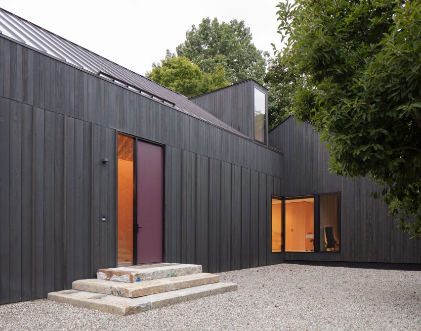 Entrance to a black timber barn-style home