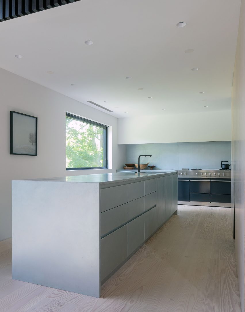 Interior kitchen at the New York farmhouse by Worrell Yeung with white kitchen island