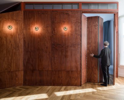 Red-stained plywood with concertina door