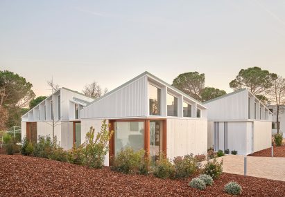 A cluster of mono-pitched square structures comprising House 016 by Arquitecturia