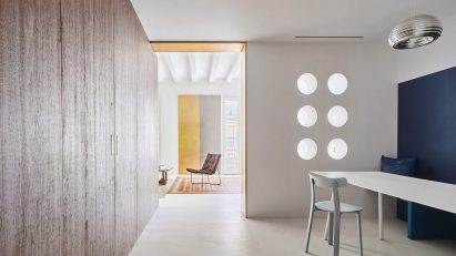 Girona Street apartment designed by Raúl Sanchez Architects features walnut wood wall