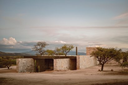 Low-slung rectilinear stone property by HW Studio