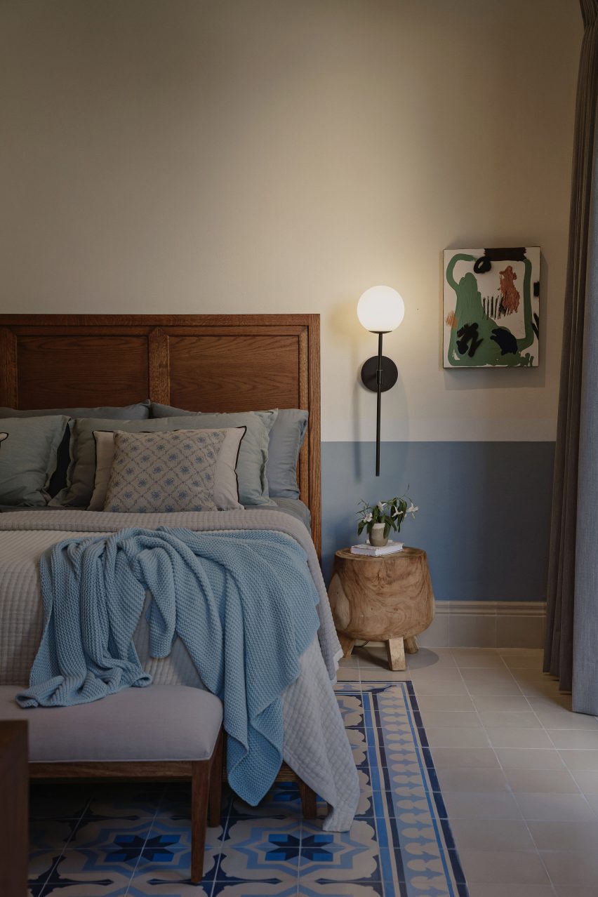 Interior of a bedroom with mosaic floor tiles at Casa Pulpo by Workshop Architects