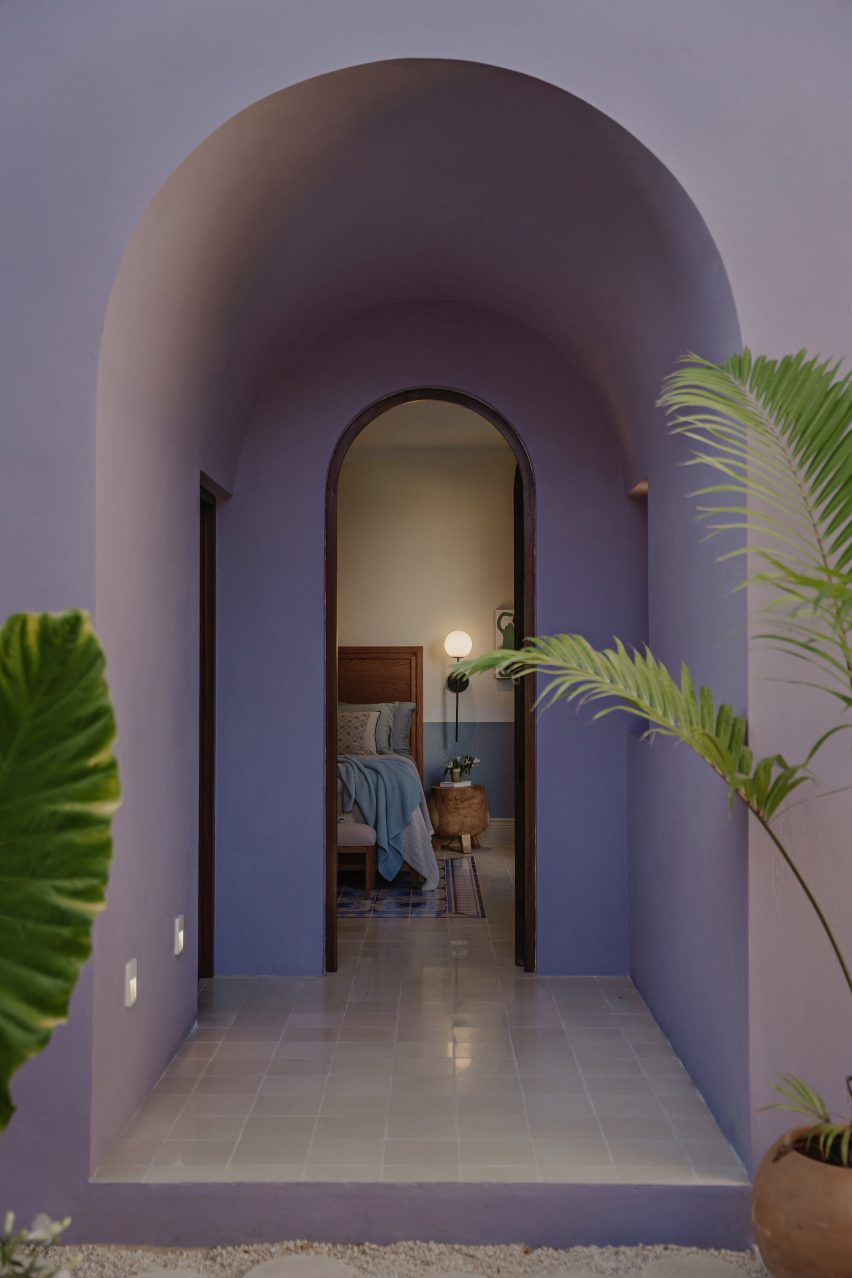 Purple arched entryway leading to a bedroom