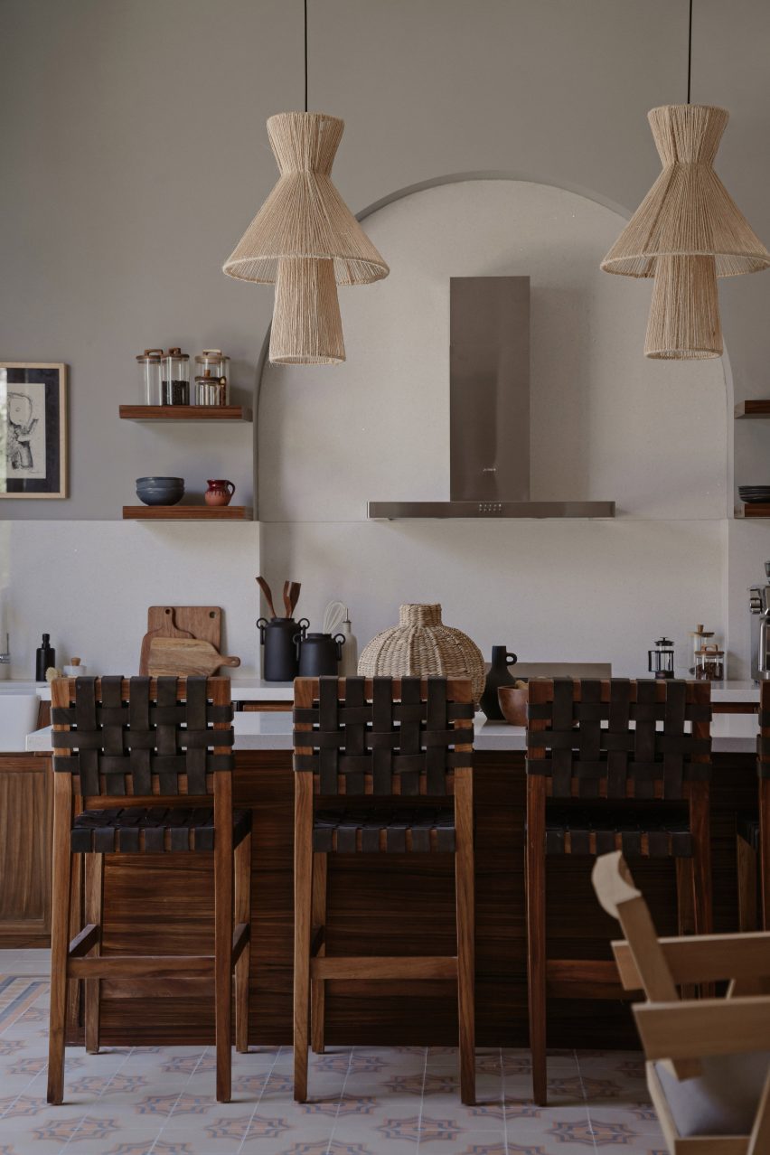 Kitchen interior with wood cabinets, white splashback and wood kitchen island