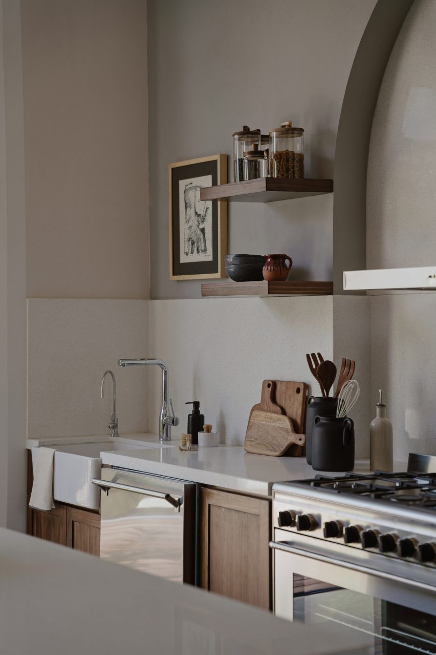 Kitchen interior with wood cabinets and white splashback
