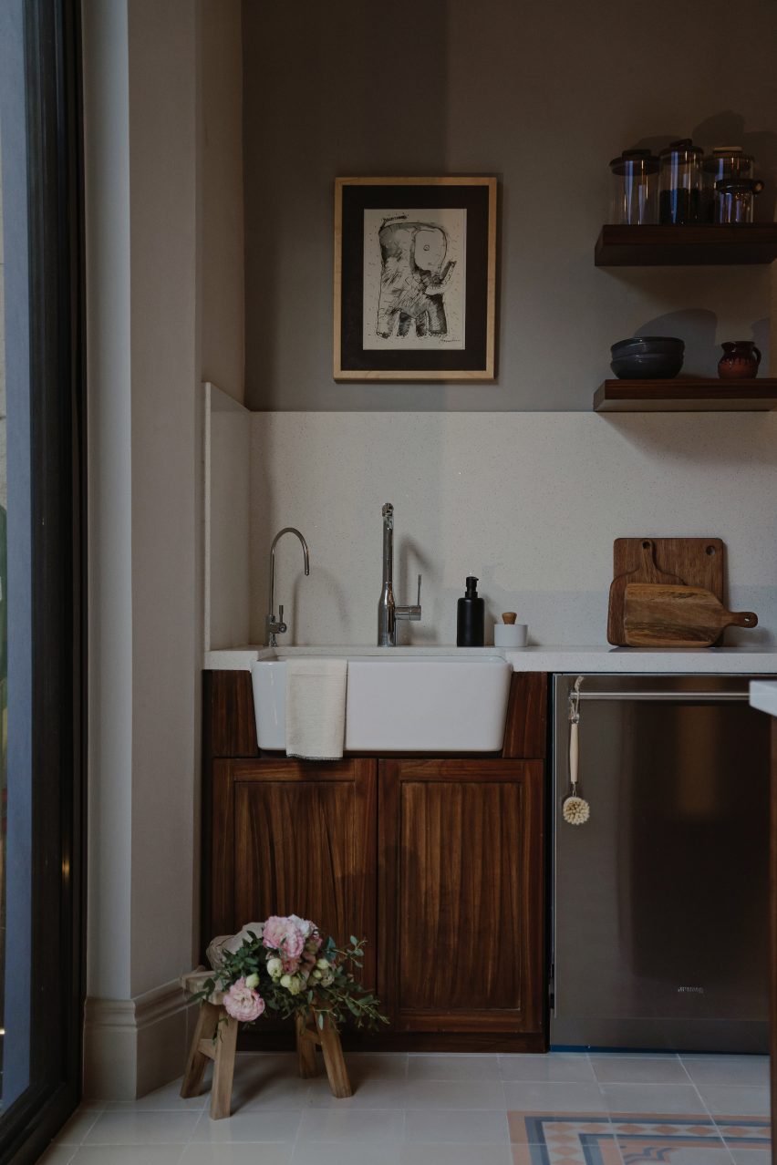 Kitchen interior with wood cabinets and white splashback
