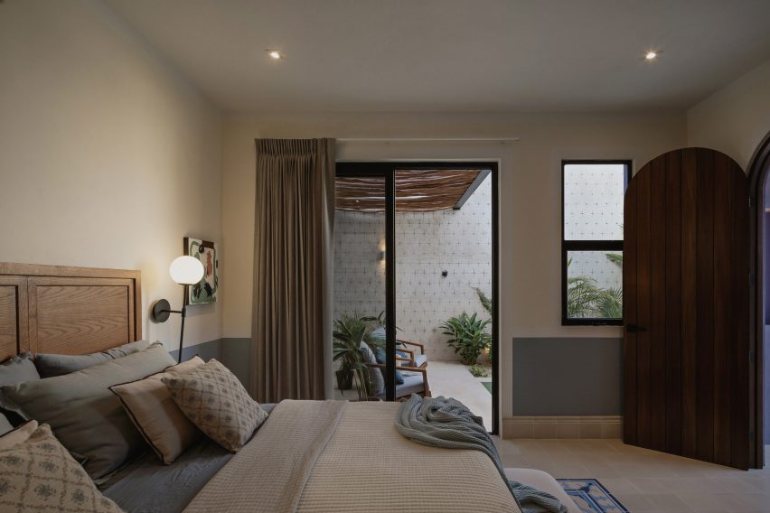 Interior of a bedroom with mosaic floor tiles at Casa Pulpo by Workshop Architects