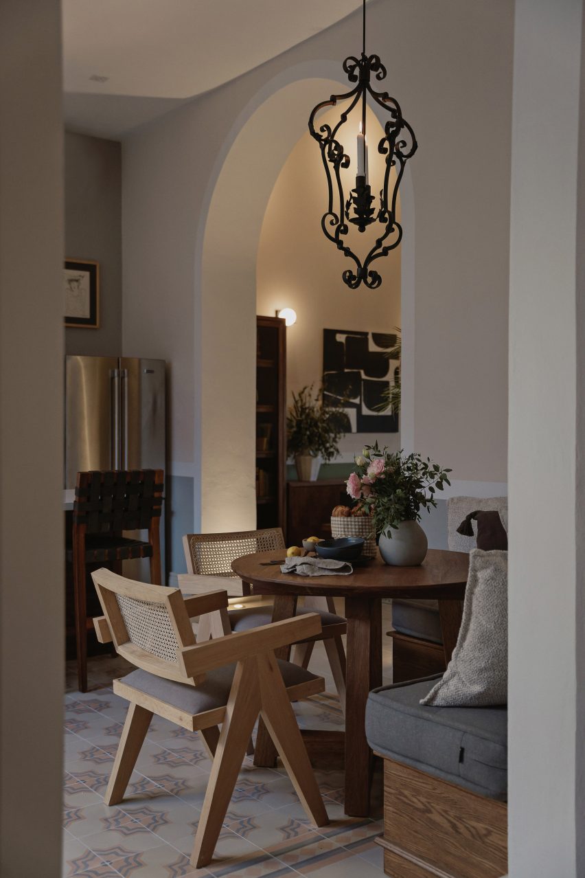 Interior dining space with wooden furniture and mosaic floor tiles