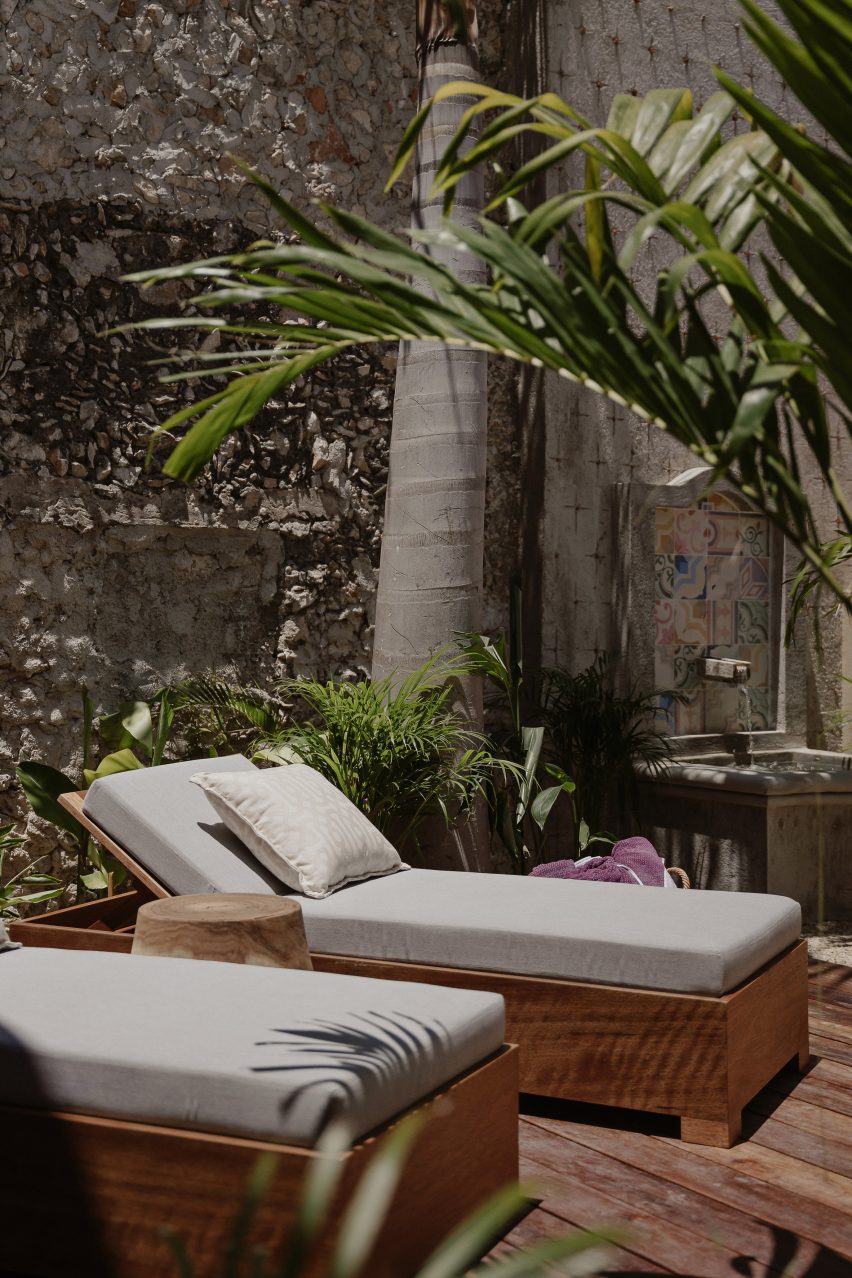 Outdoor sun loungers with palm trees
