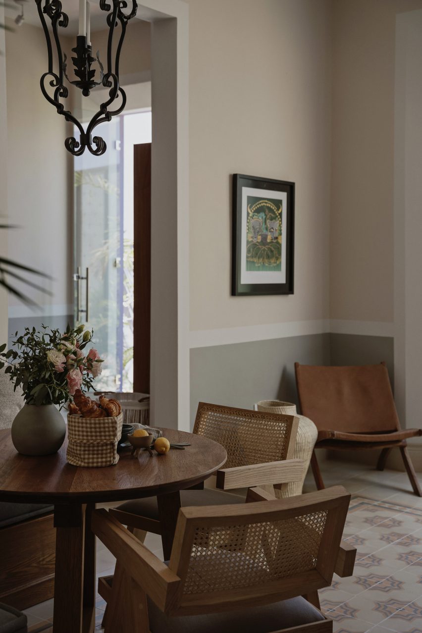 A dining area with wooden furniture and mosaic floor tiles