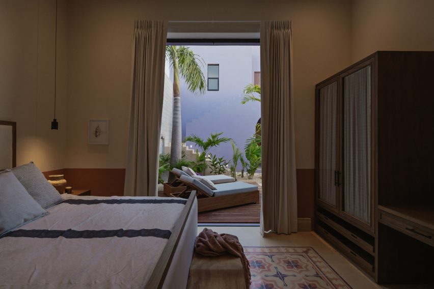 Interior of a bedroom with mosaic floor tiles at Casa Pulpo by Workshop Architects