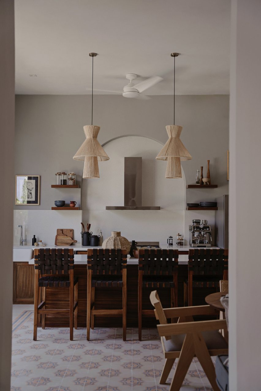 Kitchen interior with a white and wood island and mosaic floor tiles