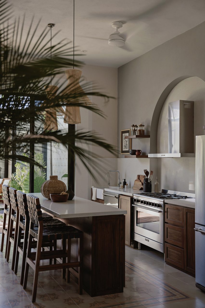 Kitchen interior with a white and wood island and mosaic floor tiles