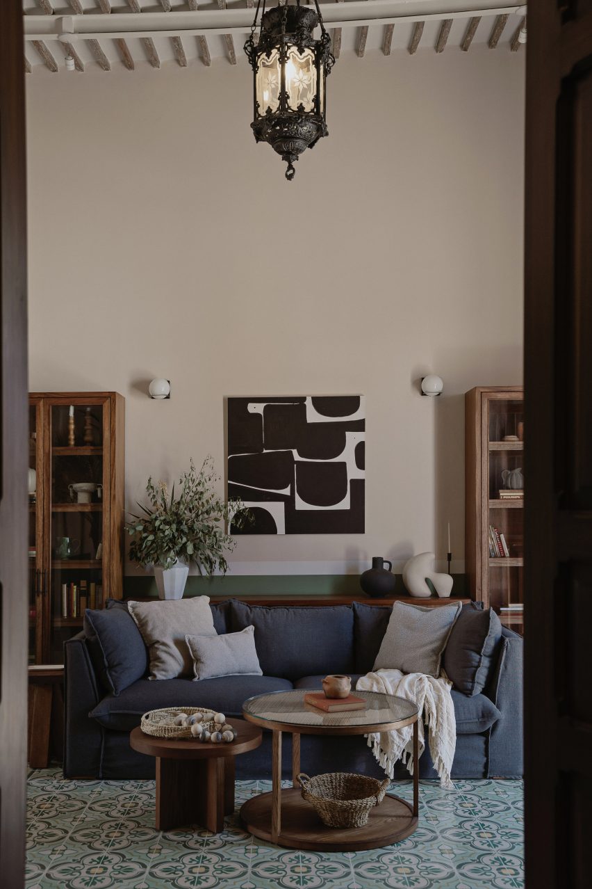 Living room interior with mosaic floor tiles and a blue sofa
