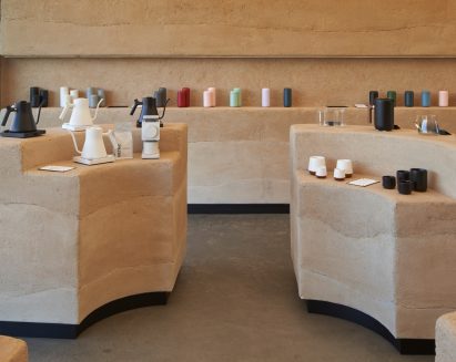 Shop interior with Clayworks rammed earth wall and rammed earth display islands