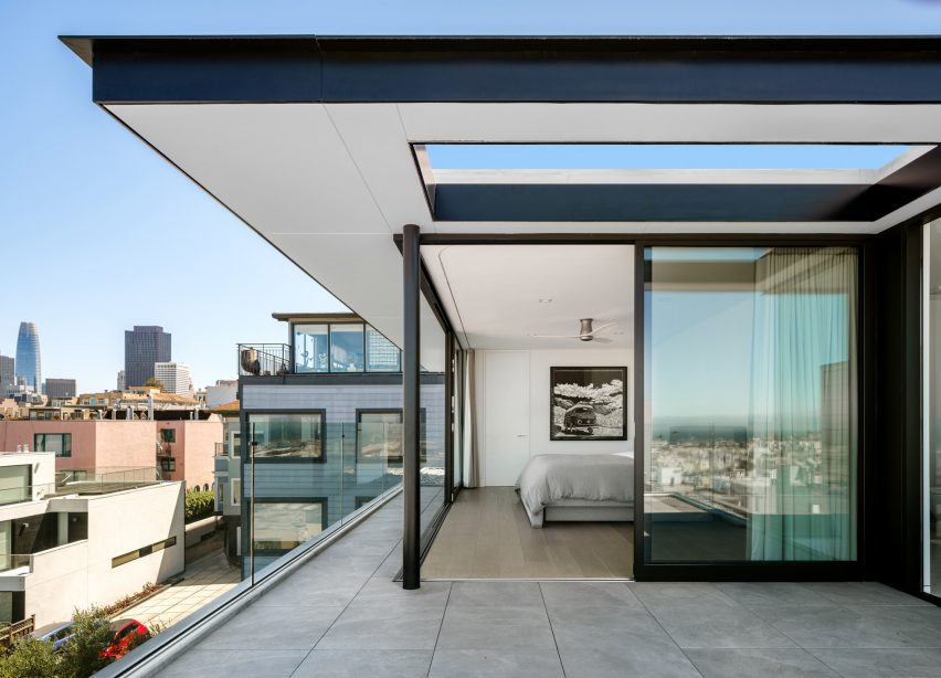 Outdoor terrace at Red Stair House by Dumican Mosey leading to a bedroom