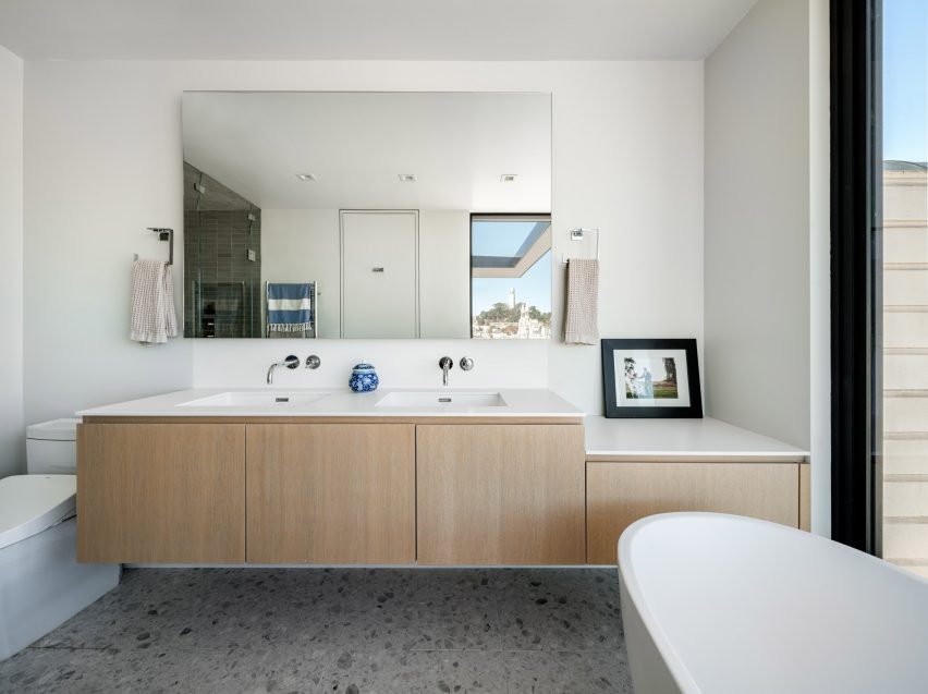 Bathroom with white walls and wood vanity units