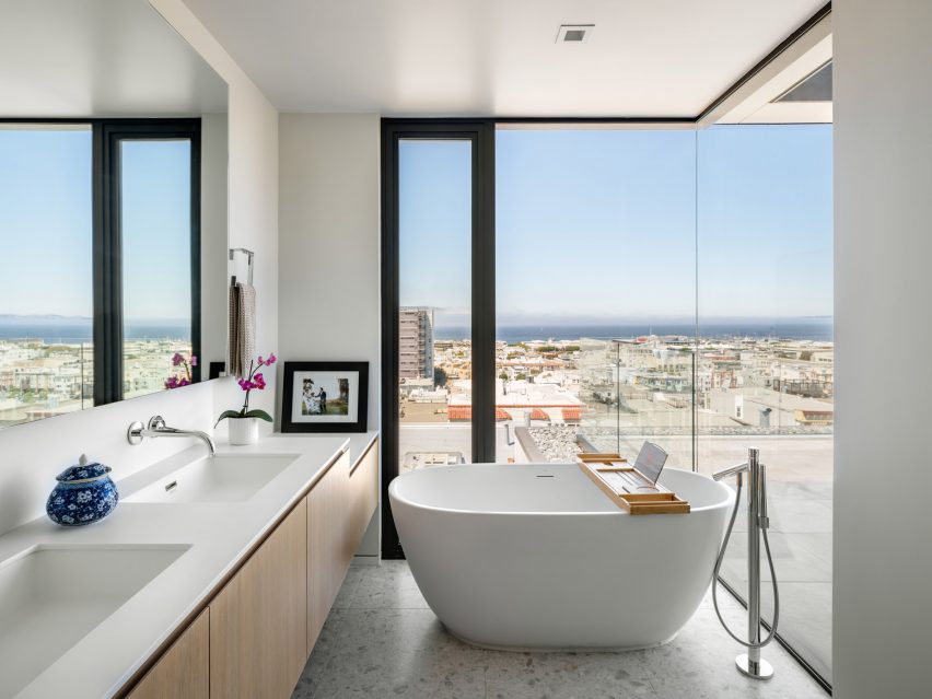 Bathroom with freestanding bathtub and corner window
