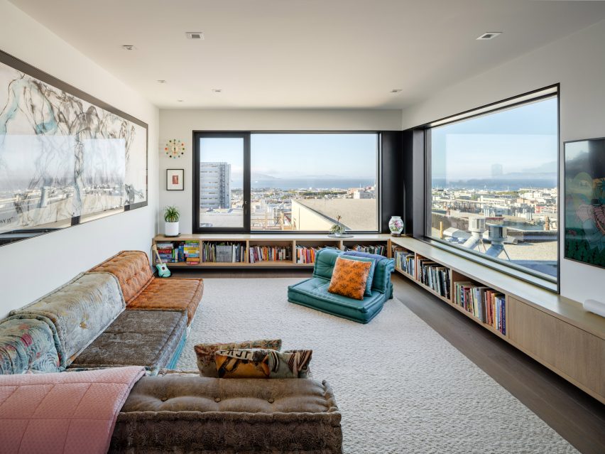 Living room with multi-colour sofas, lounge chairs and corner window