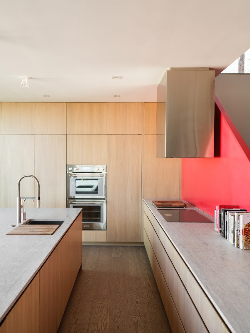 Kitchen with red staircase and wood kitchen units