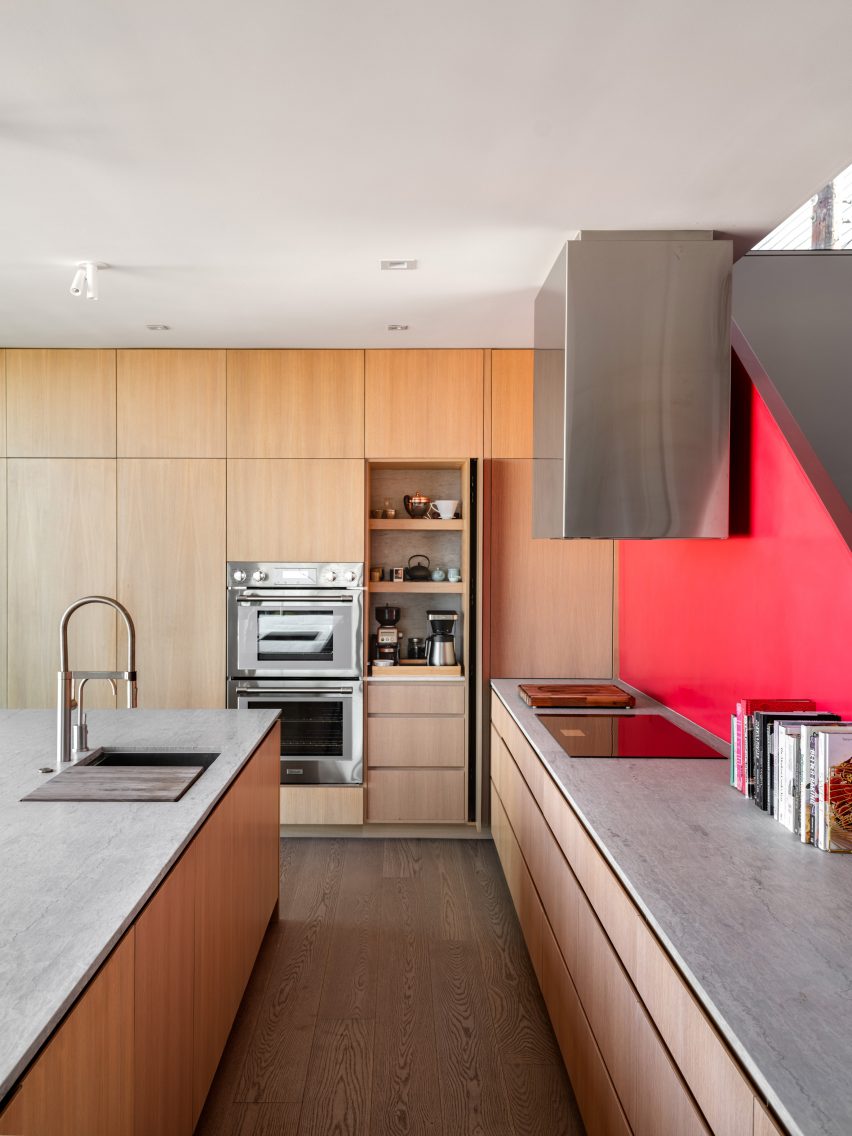 Kitchen with red staircase and wood kitchen units
