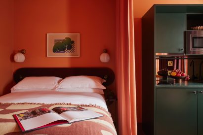 Bed and kitchen in Kensington hotel by Atelier Ochre and House of Dré