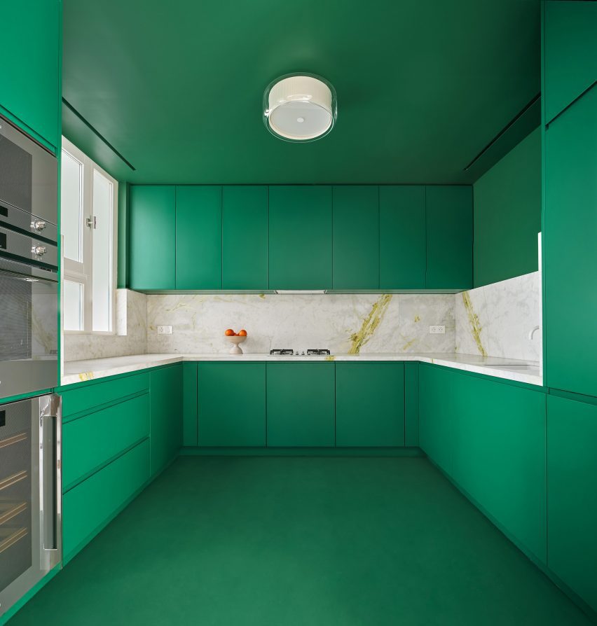 Green kitchen interior of Girona Street apartment in Barcelona, designed by Raúl Sanchez Architects