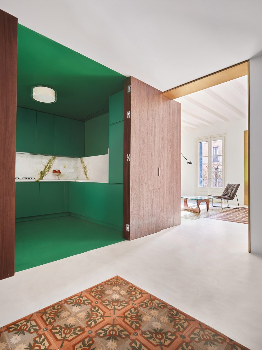 Green kitchen interior of Girona Street apartment in Barcelona, designed by Raúl Sanchez Architects